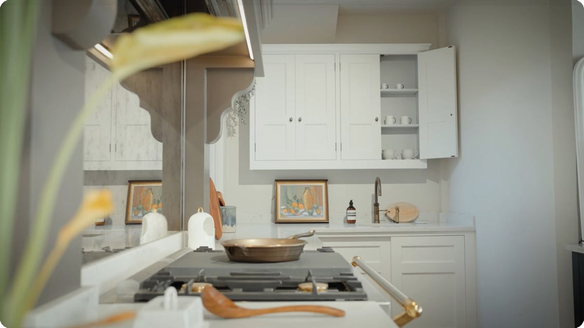 A modern kitchen featuring white cabinets and a stove